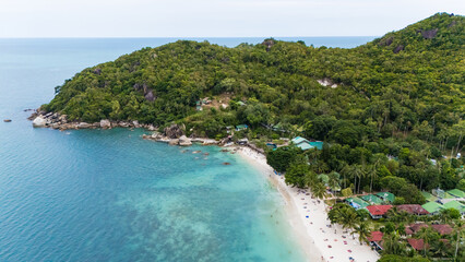 aerial drone shot of silver beach, koh samui, thailand. turquoise water, white sand, palm trees, and lush greenery create a serene tropical paradise, perfect for travel and tourism imagery. © Enrique