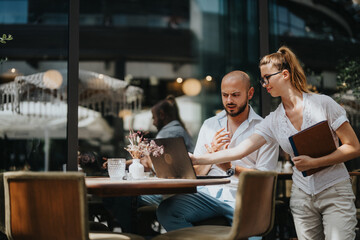 Business workers collaborating together on a project in a coffee bar, brainstorming ideas and sharing knowledge for solutions, working remotely