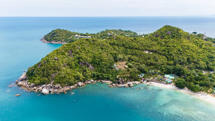 aerial drone shot of silver beach, koh samui, thailand. turquoise water, white sand, palm trees, and lush greenery create a serene tropical paradise, perfect for travel and tourism imagery.