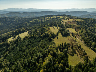 Fototapeta premium Beskid Maly aerial panorama of potrojna hill and czarny gron.Little Beskids mountain range in summer.Aerial drone view of Rzyki Village in Beskid Maly Poland.Czarny gron ski resort in Rzyki.
