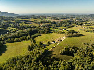 Obraz premium Beskid Maly aerial panorama of potrojna hill and czarny gron.Little Beskids mountain range in summer.Aerial drone view of Rzyki Village in Beskid Maly Poland.Czarny gron ski resort in Rzyki.