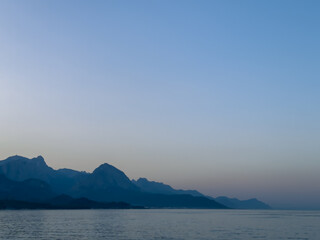 Incredibly beautiful sea sunset against the backdrop of mountains and calm water. Very beautiful...