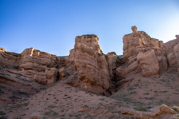 A stunning Charyn canyon in the desert beneath a bright blue sky