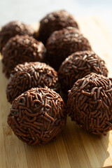 Close-up of chocolate-covered treats on a wooden board. 