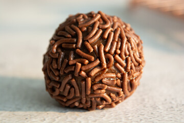 Close-up of a delicious chocolate brigadeiro, a popular Brazilian treat.