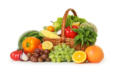 Different fresh fruits and vegetables in wicker basket isolated on white
