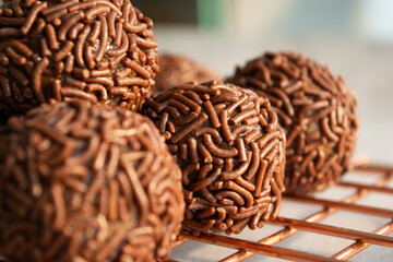 Close up of Brazilian brigadeiros, a chocolate dessert covered in sprinkles.