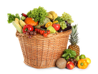 Different fresh fruits and vegetables in wicker basket isolated on white