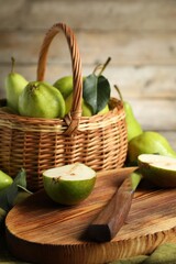 Fresh green pears, board and knife on table