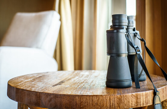 binoculars on wood table