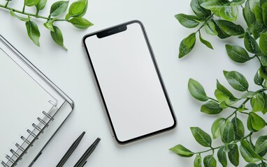 Minimalist mockup of a blank iPhone screen with green leaves and office supplies for modern presentations