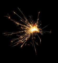 Fototapeta premium Christmas sparkler burning isolated on black background...