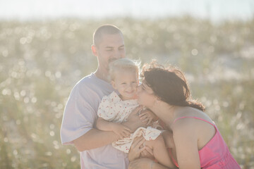 Fototapeta premium Cheerful family with father, mother, daughter