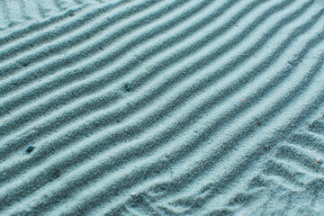 textured blue sand background, beautiful sand texture, overhead view of blue sand, zen pattern drawn in the sand, Top view of fine grain texture