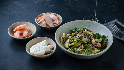 Green salad with cucumbers, lettuce, spinach, green peas, flax seeds and pumpkin and shrimps, chicken ham and eggs.