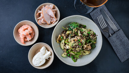 Fresh salad with cucumbers, lettuce, spinach, green peas, flax seeds and pumpkin and shrimps, chicken ham and eggs.