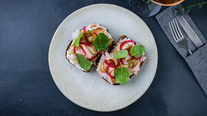Bruschetta with chicken ham, cucumbers, red onions, grapes, spinach and cream cheese.