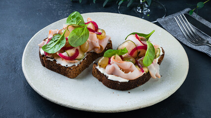 Fresh bruschetta with chicken ham, cucumbers, red onions, grapes, spinach and cream cheese.