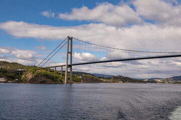 Passing Under the Askøy Suspension Bridge Across the Byfjorden, From the deck of a cruise ship leaving Bergen, Norway in Summer