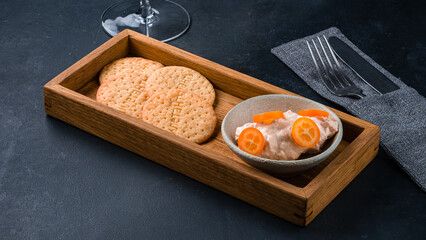 Sweet crackers with sweet cream sauce and kumquat.