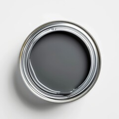 An open tin can displays a fresh layer of grey paint, revealing its smooth, even texture that reflects light. The can is positioned on a pristine white background.