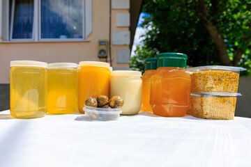 Natural products of beekeeper farmer including different types of honey, pollen and propolis on the table