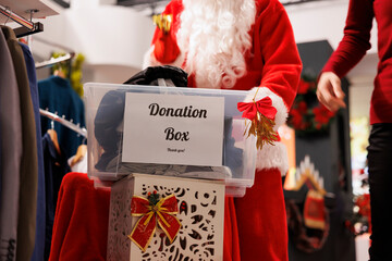 Clients collecting items in box for donation to help santa claus man spread positivity and...