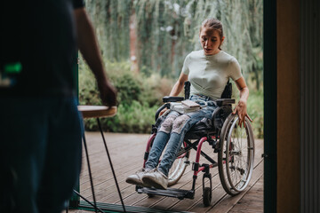 A young woman using a wheelchair navigates through a doorway outdoors, showcasing independence and...