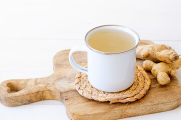 Ginger tea in a mug on a white background
