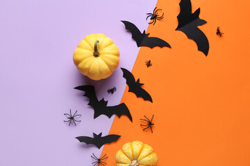 Paper bats with spiders and fresh pumpkins for Halloween party on colorful background