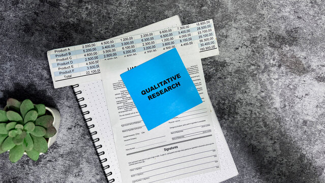 Concept of Qualitative Research write on sticky notes isolated on Wooden Table.