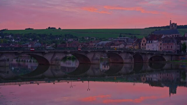 Twilight time illumination Joigny city famous. Yonne riverside downtown panorama. Sunset view of river