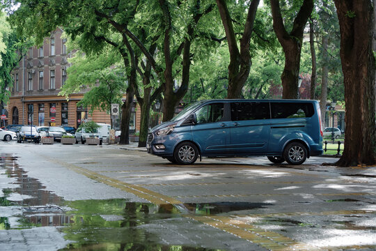 Passenger MPV Ford Tourneo Custom in blue color (1st generation facelifted, related Ford Transit Tourneo Connect). Subotica, Serbia, 05.06.2024