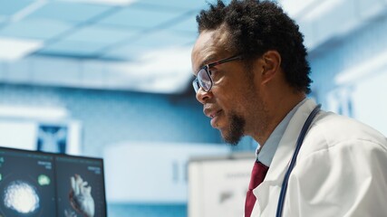 Male physician doing an x ray diagnostics scan interpretation during check up visit, discussing about recovery treatment in cabinet. Doctor examining radiography test results for a patient. Camera A.
