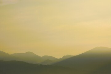 hill view during mist at sunrise