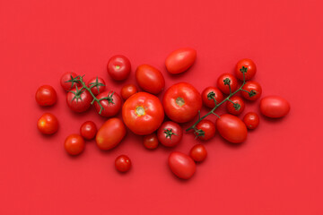 Fresh ripe tomatoes on red background