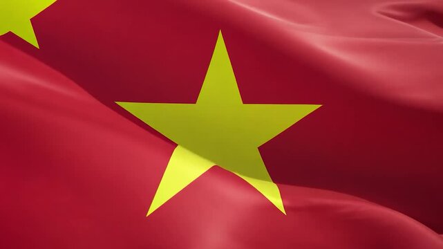 A bold red flag featuring a large yellow star flutters in the breeze, symbolizing national pride for Vietnam amidst a clear sky