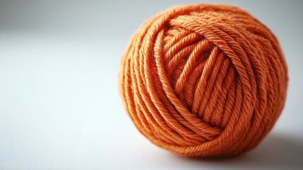 A Close Up of a Soft, Warm Orange Yarn Ball with a Fuzzy Texture