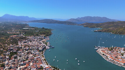 Fototapeta premium greece peloponnese region poros island houses clock tower and boats aerial view on daylight
