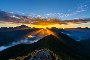 Fototapeta premium A breathtaking mountain range at sunrise, with golden light spilling over the peaks and mist rising from the valleys below