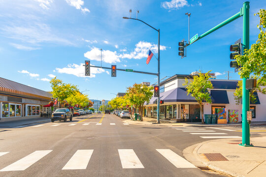 The main street, Sherman Avenue, on a sunny day in early Autumn in historic downtown Coeur d'Alene, Idaho, with the lake and resort clock in view in the distance.