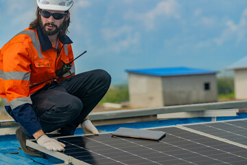 Worker Technicians are working to construct solar panels system on roof. Installing solar photovoltaic panel system. Men technicians walking on roof structure to check photovoltaic solar modules.