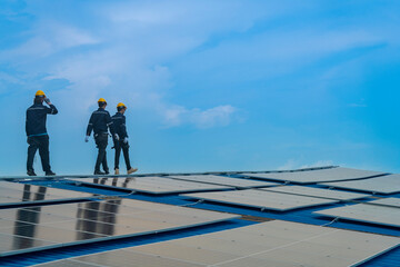 Worker Technicians are working to construct solar panels system on roof. Installing solar photovoltaic panel system. Men technicians walking on roof structure to check photovoltaic solar modules.