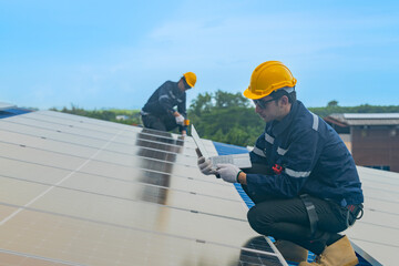 Worker Technicians are working to construct solar panels system on roof. Installing solar photovoltaic panel system. Men technicians walking on roof structure to check photovoltaic solar modules.