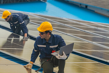 engineer man inspects construction of solar cell panel or photovoltaic cell by electronic device....