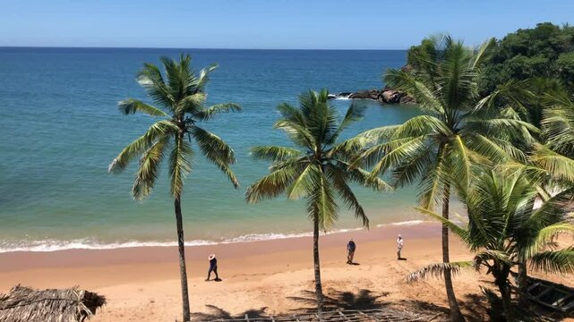 Tourists exploring the amazing and exotic Caribbean pristine beach Playa Medina in the Gulf of Paria from where Christopher Columbus discovered Venezuela. He called land it of grace