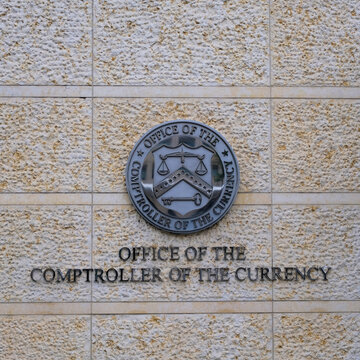 Office of the Comptroller of the Currency (OCC) logo and lettering on Washington, DC headquarters building wall