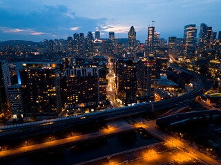 Fototapeta premium Montreal skyline illuminated at dusk and reflected in the water, Quebec, Canada