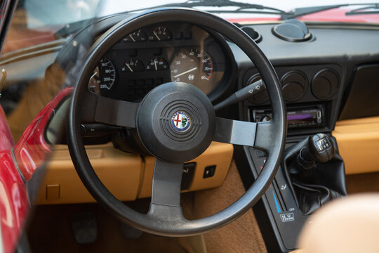 alfa romeo duetto spider, interior from the cockpit, steering wheel with prominent emblem, car famous throughout the world after the Dustin Hoffman film of the 70s.
