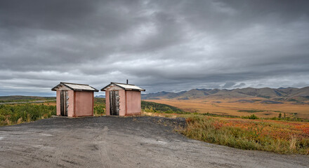 Pink outhouses on the Dempster Highway at the Arctic Circle in the Yukon Territory, Canada